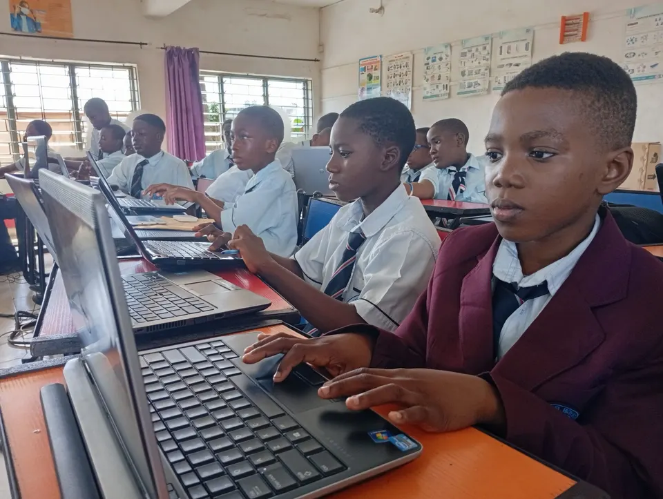 A student concentrating on a coding exercise during a Techbase class in Lagos