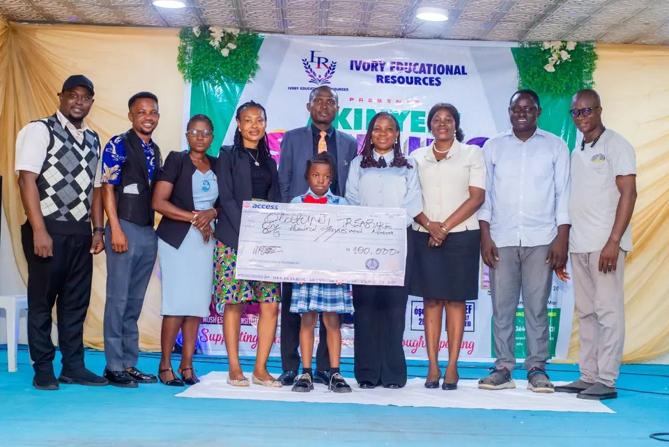 Organisers and winners holding prize cheques at the Akinyele Spelling Challenge 2026